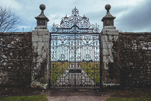 Golspie/UK-22/3/18: Wrought iron gate of the Dunrobin Castle in the Highland area of Scotland, looking at the Moray Firth a roughly triangular inlet of the North Sea