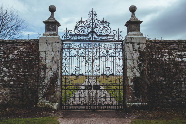 Wrought iron gate of the Dunrobin Castle in the Highland area of Scotland Golspie/UK-22/3/18: Wrought iron gate of the Dunrobin Castle in the Highland area of Scotland, looking at the Moray Firth a roughly triangular inlet of the North Sea moray firth stock pictures, royalty-free photos & images