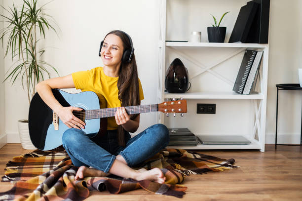 istock Woman spends leisure playing guitar 1217987497