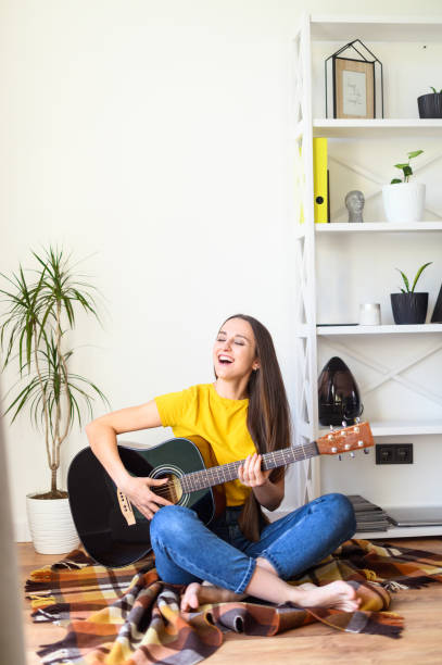 istock Woman spends leisure playing guitar 1217987503