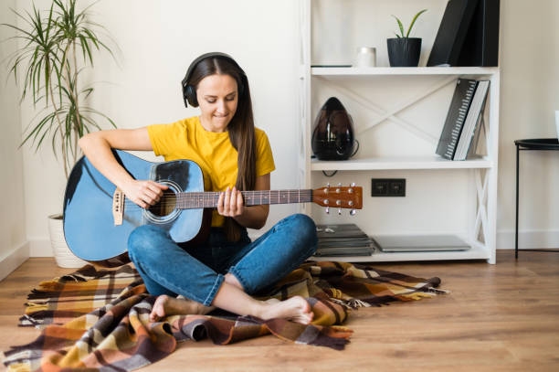 istock Woman spends leisure playing guitar 1217987505