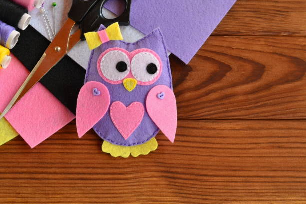 istock A cute felt owl toy. Scissors, sheets of felt, thread, needles. Sewing kit to make projects. How to make a toy. Easy felt sewing crafts for kids 1217987669