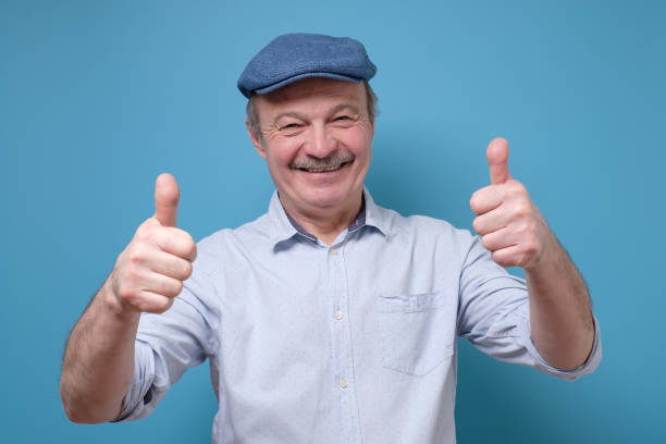 istock man in summer hat showing thumb up approving your choice 1217988669