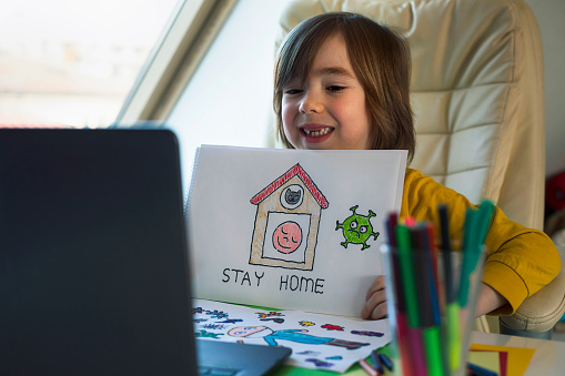 Little boy drawing at home. E-learning. Preschool age education. Coronavirus outbreak. Stay home.