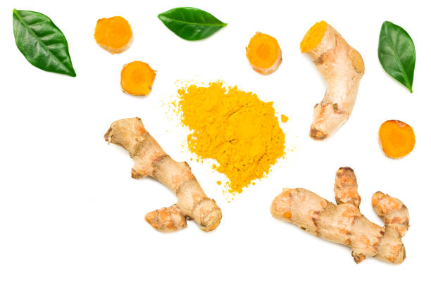 istock Turmeric powder with turmeric root isolated on white background. Top view. 1217992873