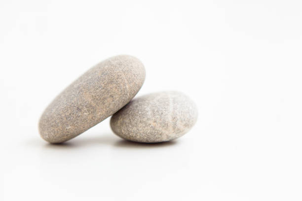 istock Set of two pebbles on the white background 1217994861