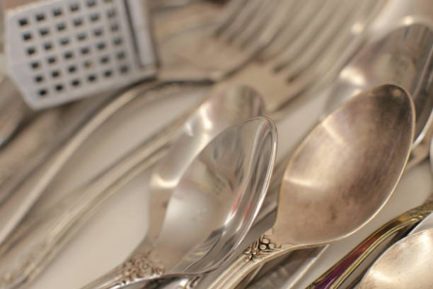 istock empty dinnerware on white table background. household items: spoons, forks, knives 1217996422