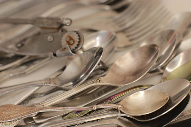 istock empty dinnerware on white table background. household items: spoons, forks, knives 1217996462