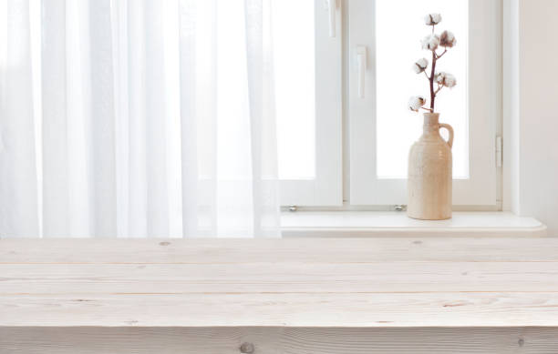istock Wooden planks table for product display on window sill background 1217997252