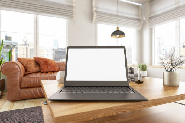 istock Laptop Computer on a Table Defocused Apartment Living Room 1217997286