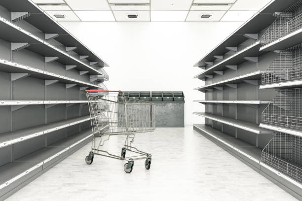 istock Empty Shelves at a Grocery store with Shoping Cart 1217997522