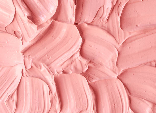 istock Pale pink cosmetic clay (rhassoul, facial mask, face cream, body wrap) texture close up, selective focus. Abstract background with brush strokes. 1217997883