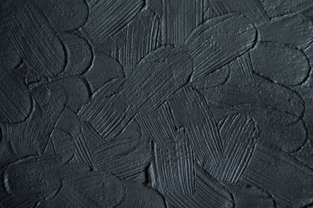 istock Black cosmetic clay (charcoal facial mask, cream, body wrap) texture close up. Abstract background with brush strokes. Selective focus. 1217998962