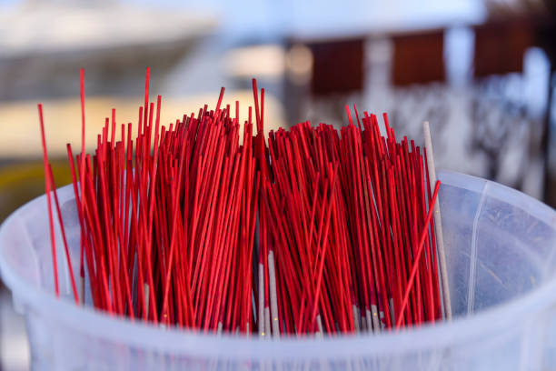 Plastic bucket containing incense sticks, Thailand
