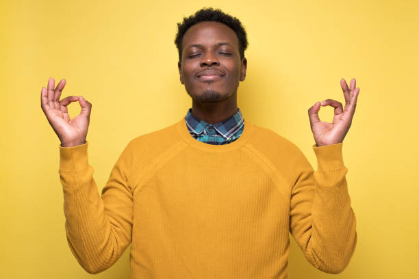 istock african man meditates tries to relax in self isolation or quarantine 1217999121