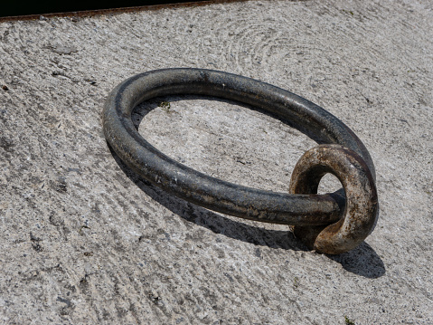 Old cast iron ring. It is on a harbor and you can affix your boat with it.