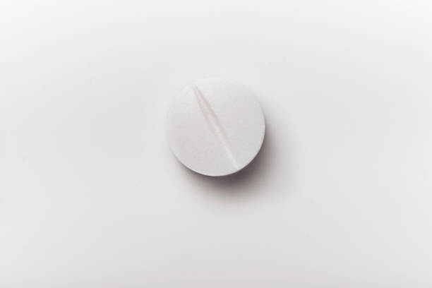 istock Close-up of white pill isolated on white background. 1218000168