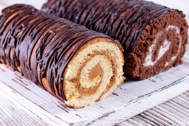 istock Chocolate and white cream sponge roll. Two biscuit rolls. 1218000203