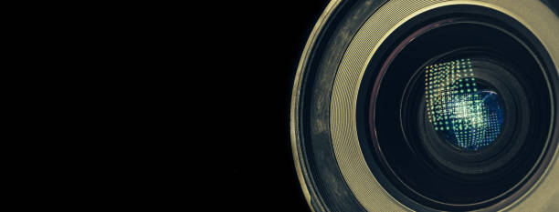 istock CLOSE UP Beautiful camera lens with light reflection on a black Background pattern for design. 1218000353