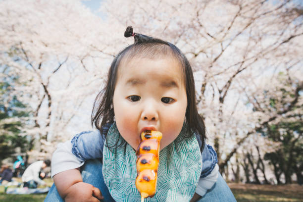 istock Baby eating dango in the park 1218000686