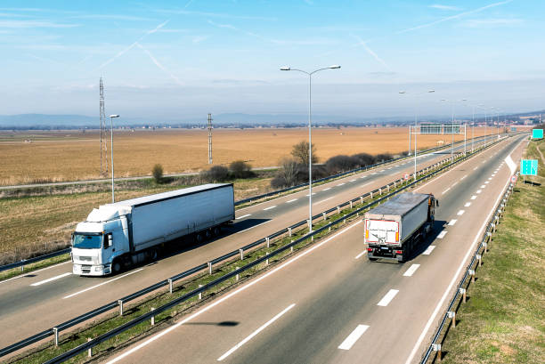 istock Transportation trucks passing by on asphalt highway 1218001299