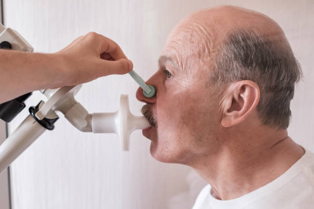 Senior hispanic man man testing breathing function by spirometry. Senior hispanic man man testing breathing function by spirometry. Diagnosis of respiratory function in pulmonary disease human cardiopulmonary system audio stock pictures, royalty-free photos & images