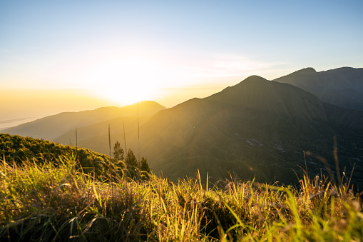 (Selective focus) Stunning view of a mountain range illuminated by a beautiful sunrise. Lombok Island, Indonesia.