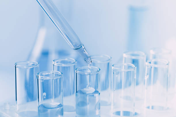istock Laboratory glassware with a dropper dripping liquid into a test tube. scientific laboratory test tubes, laboratory equipment 1218006425