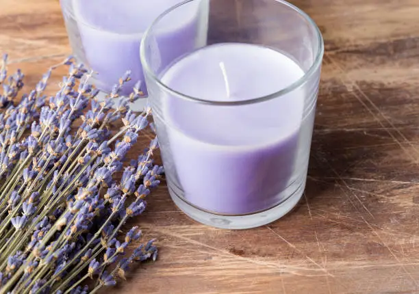 Dry lavender flowers and candle lavender color