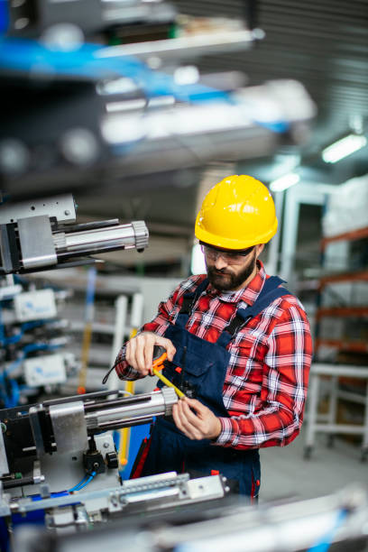 istock Worker in factory on machine 1218007379