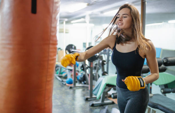 istock Young woman working on punches at the gym 1218007840