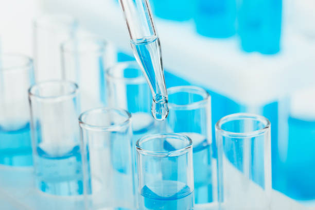 istock Laboratory glassware with a dropper dripping liquid into a test tube. scientific laboratory test tubes, laboratory equipment 1218008128