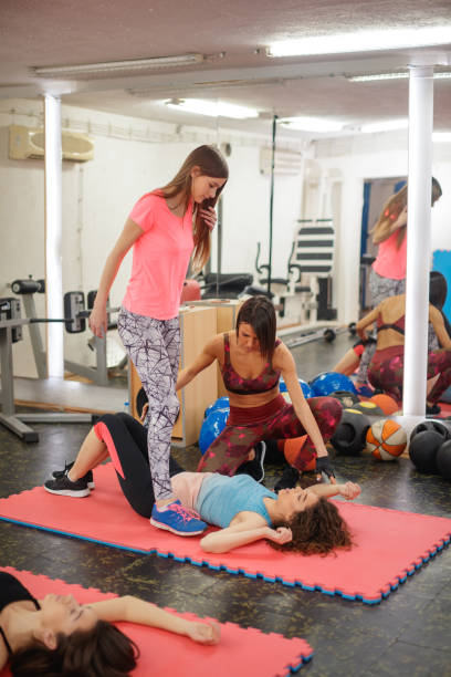 istock Fitness instructor teaching gym-goers how to stretch 1218008250