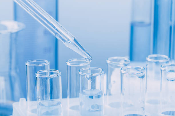 istock Laboratory glassware with a dropper dripping liquid into a test tube. scientific laboratory test tubes, laboratory equipment 1218009775