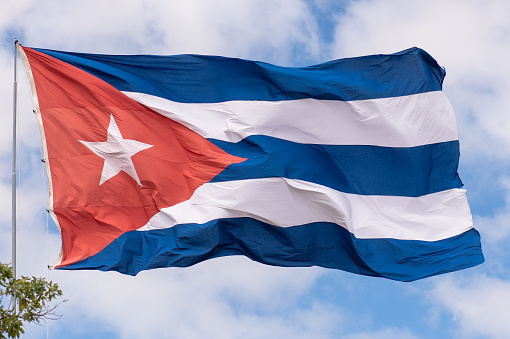 Beautiful large Cuban National flag waving in a windy day and with blue sky