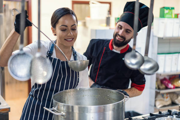 istock Female cook preparing meal in the restaurant kitchen 1218010291