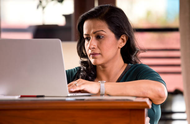 istock Frustrated woman reading document at home office 1218010324