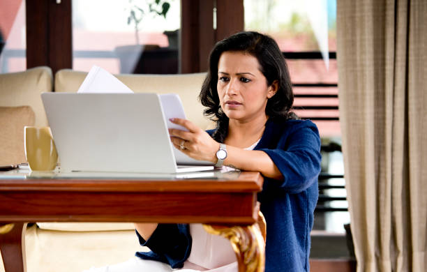 istock Frustrated woman reading document at home office 1218011022
