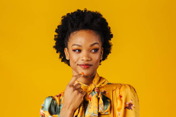 portrait of a happy excited young woman smiling and looking to side in an elegant floral fashion top - aspirations choice choosing women imagens e fotografias de stock