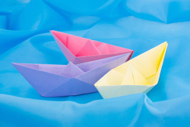 istock paper boats on a blue background 1218015060