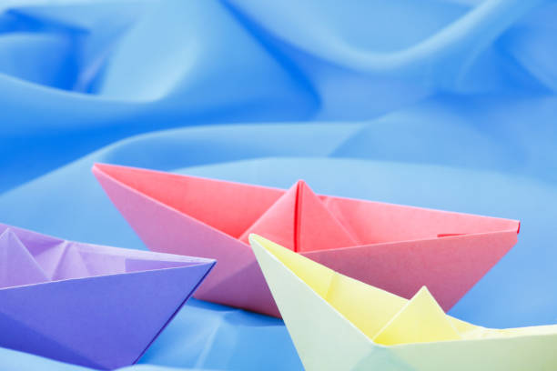 istock paper boats on a blue background 1218015130