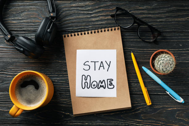 istock Notebook with Inscription Stay home on wooden background. Quarantine 1218015197