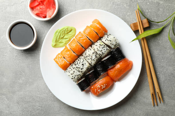 istock Plate with sushi rolls on gray background. Japanese food 1218017444