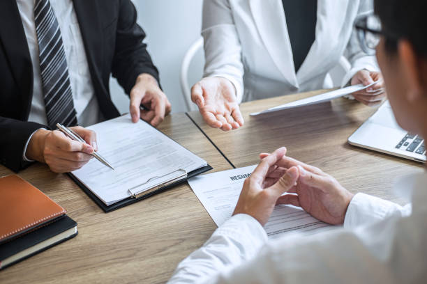 istock Midsection Of Business People Interviewing Man In Office 1218021885
