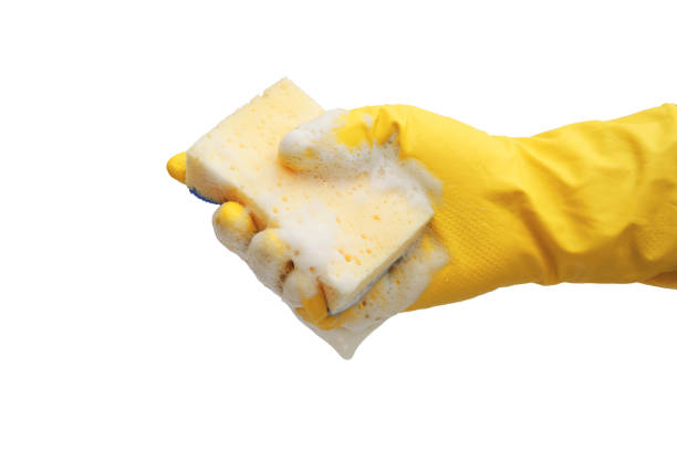 istock hand in rubber yellow glove holding soapy sponge isolated on white background 1218022205