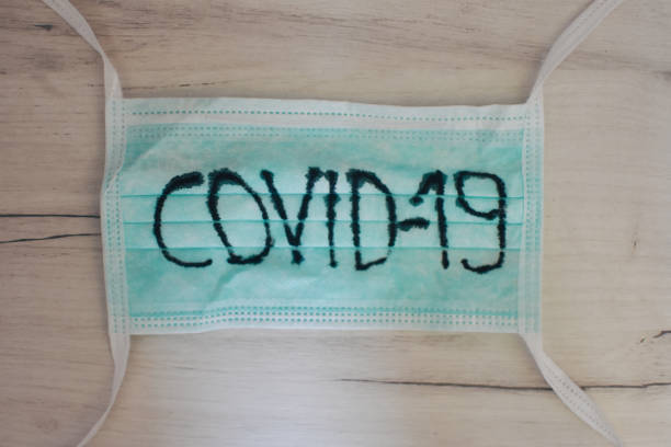 istock Medical mask, protective mask with COVID-19 text. Chinese coronavirus outbreak situation. Novel coronavirus COVID-19, WUHAN virus concept 1218025131