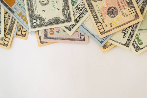 istock Side frame of different dollar cuperas randomly lie on a white background. Concept business, monetary fund. 1218026345