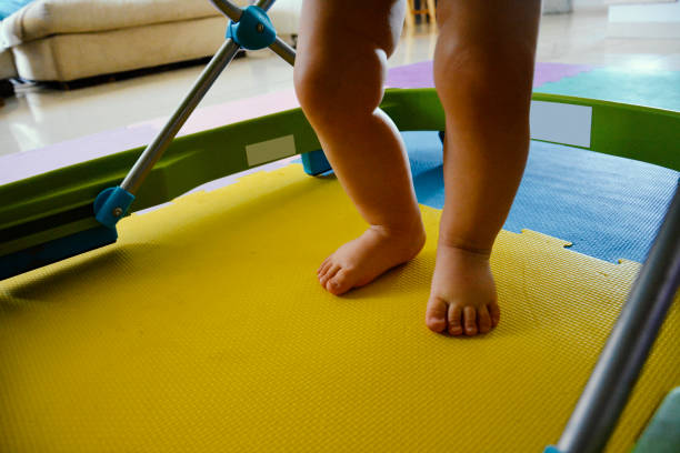 Baby Walking with the Help of a Walker stock photo