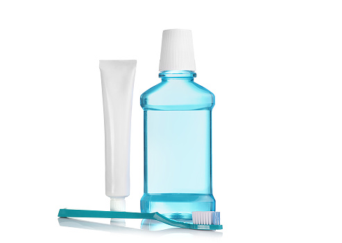 Mouthwash, toothpaste in white tube and toothbrush isolated on white background