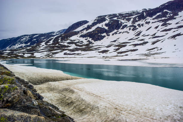 istock Mountain landscape with the lake formed by melting snow. 1218028704